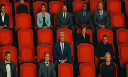 several businessmen sitting next to each other in rows