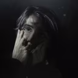 a woman with hands on her face holding her mouth