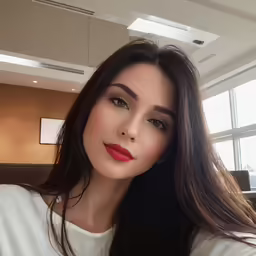 an attractive woman with long black hair wearing red lipstick