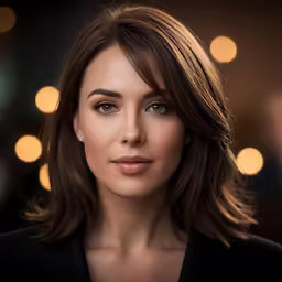 a woman standing in front of a christmas lights