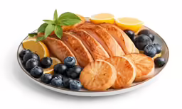 some orange slices lemons blueberries and a black pepper