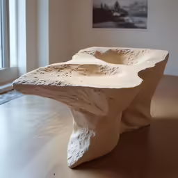 a white sculpture in front of a window in a room