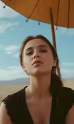 a woman with an umbrella behind her, in the desert