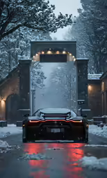 a car driving through an open archway in the snow