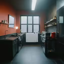 a kitchen area with a window and tiled floors