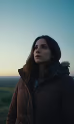 a woman is looking up at the sky