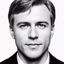 a black and white photo of a man in a suit