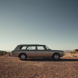 a vintage car is sitting in the desert