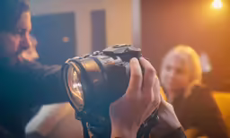 a man is photographing another woman with a camera