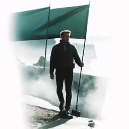 a man holding a flag and standing in the snow