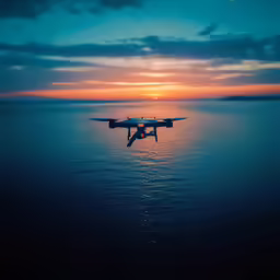 a seaplane flying above the water as the sun sets