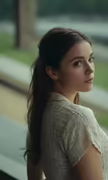 a beautiful woman wearing long hair looking at the camera
