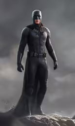 the batman in a costume stands on rocks under a cloudy sky