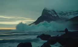 person standing in front of a mountain with large waves