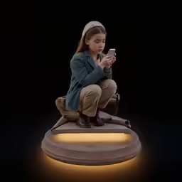 a woman kneeling down looking at her phone
