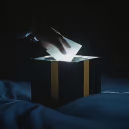 a person is placing something into a small box