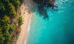 an aerial view of the ocean and land next to a beach