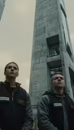 two people stand with their backs turned as they stare in opposite directions