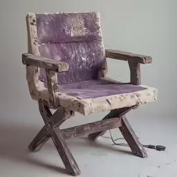 an old wooden chair with a purple leather seat