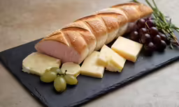 a ham sandwich with grapes and grapes