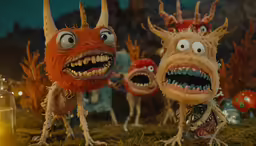 a group of cartoon monsters are in the grass