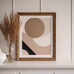 a white fireplace with a picture frame on the mantle
