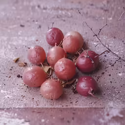 a pile of red cherries on top of a counter