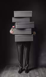 a person is carrying some books over his head