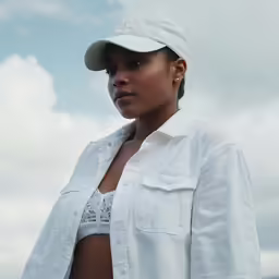 a beautiful young woman wearing a white hat and shirt