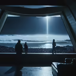 people standing in front of a window looking at an ocean