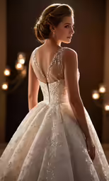 a woman in a wedding dress standing and posing for the camera