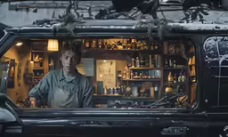 man standing in a truck with bottles on shelves