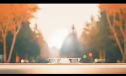 an empty white bowl sitting in front of some trees