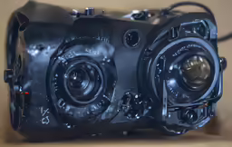 a black camera with no lenses is in the box