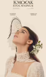 a woman wearing a white dress with a flower in her hair