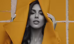 a woman with her face covered by a yellow sheet