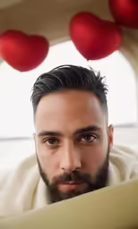man with goatee in car looking towards camera