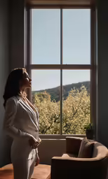 the woman is standing in front of a window