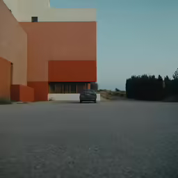 a blue truck parked in front of a red building