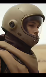 a man with a helmet on and scarf around his neck
