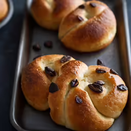 several baked rolls are sitting on a baking sheet