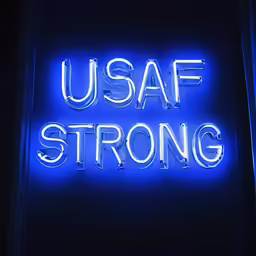 a neon sign reads, usaf strong with a blue light