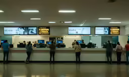 a line up of people waiting at an airport