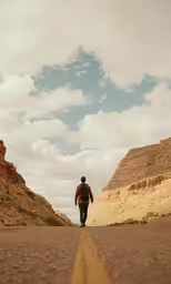 a person walking on the road in the desert