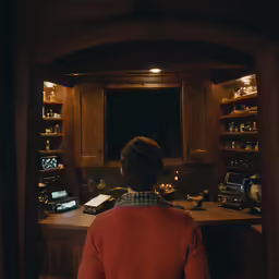 a woman sitting at a desk watching tv
