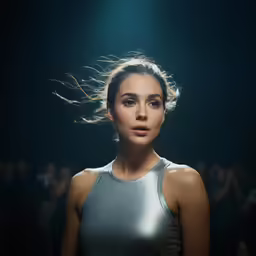 a woman in a silver dress is looking into the distance