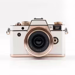 an open gold camera on a white background