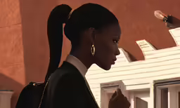 there is a woman in a suit looking away
