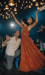two people dancing in front of some lights