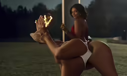 a woman kneeling down in front of a flag